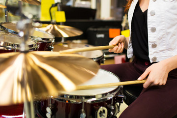 close up of woman playing cymbals at music store