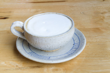 Close up Vintage cup of Coffee, latte on wooden background