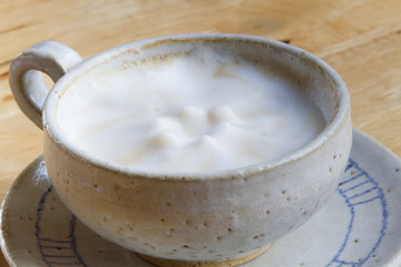 Close up Vintage cup of Coffee, latte on wooden background