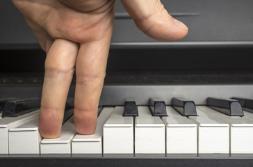 fingers click on the piano keys as if the legs 