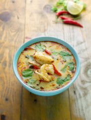 tom yum kung on rustic wood