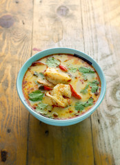 tom yum kung on rustic wood