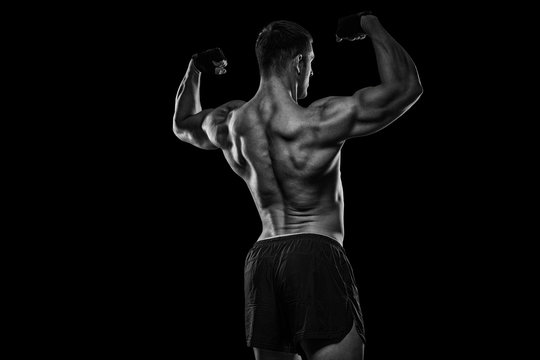 Rear view of healthy muscular young man with his arms stretched