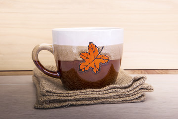 Christmas cup on wooden table.