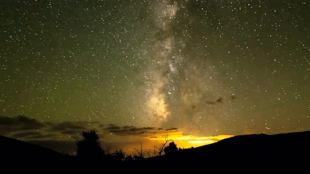 Milky Way time-lapse, clouds forming, small lightning storm, shooting stars, 4k 