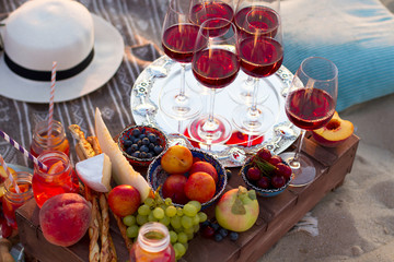 Glasses of the red wine on the sunset beach