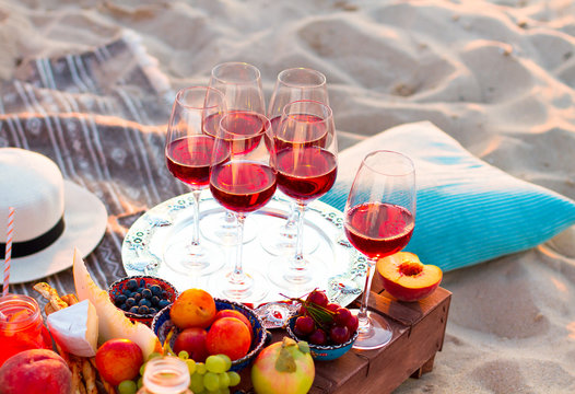 Glasses Of The Red Wine On The Sunset Beach