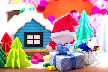 Santa Claus foled paper and small house in snow field