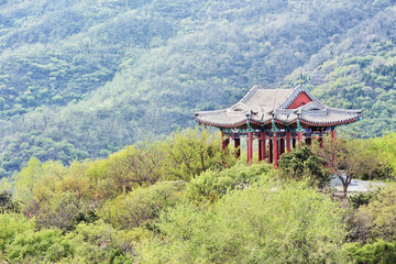 Ancient Chinese pavilion on a tranquil lush green hill