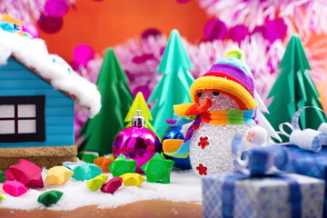 Snowman and small star paper on the snow field.