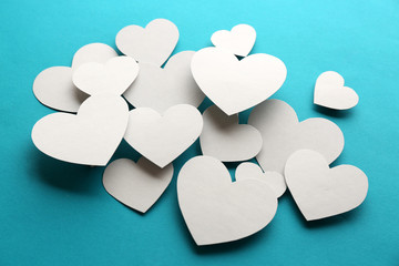 White paper hearts on blue background