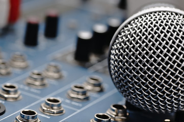Audio mixer and a silver microphone.