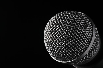 Silver microphone on a black background.