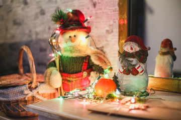 Wreath with snowman sitting on it with text Merry Christmas 