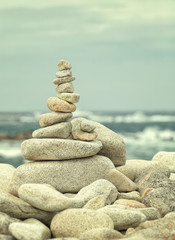 Instagram like photo of stone composition at the beach; filters applied for vintage effect; location: Pleumeur Bodou in the Brittany, France
