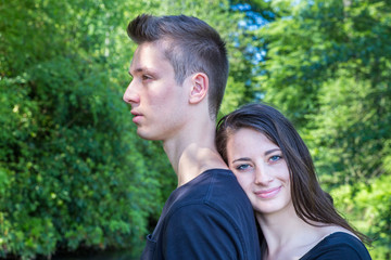 Fototapeta premium Young attractive woman leaning head on back of man