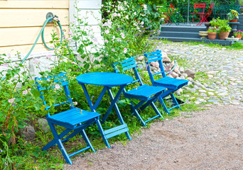 blue wooden table and chairs in the front garden