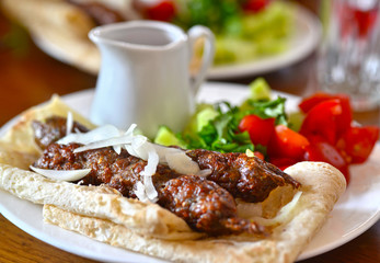 Skewers of lamb. Kebab in pita bread with sauce and vegetables. Georgian cuisine. Georgia. Tbilisi.