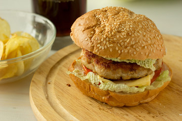 Cheeseburger on wooden plate