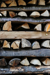 Pile of firewood criss crossed horizontally.