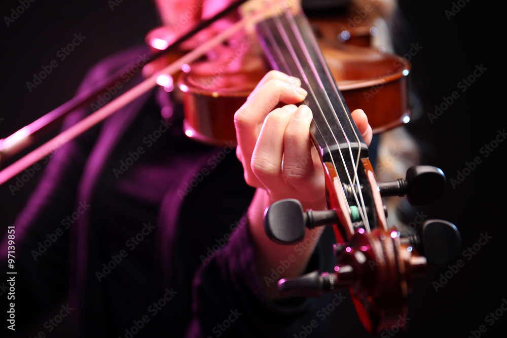 Wall mural woman plays violin on black background, close up