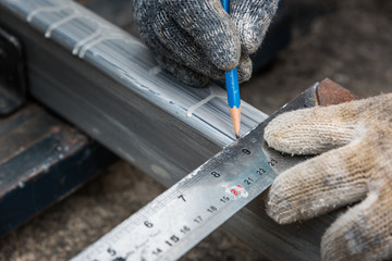 Worker measurement the steel with square triangle scale