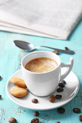Cup of coffee on color wooden background