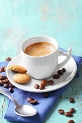 Cup of coffee on color wooden background