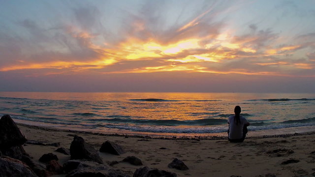 Man on the beach watching the sunrise/Gulf of Thailand