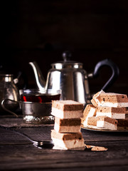 ?offee fruit candy tea and teapot on dark wooden table.