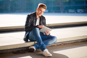 Young student with tablet outside