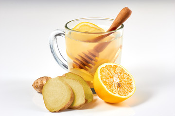 Ginger tea with lemon and honey on white background
