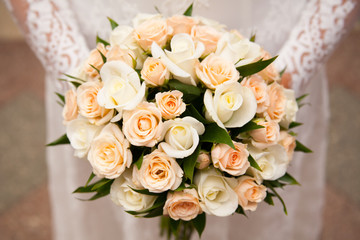 Beautiful wedding bouquet in hands of the bride