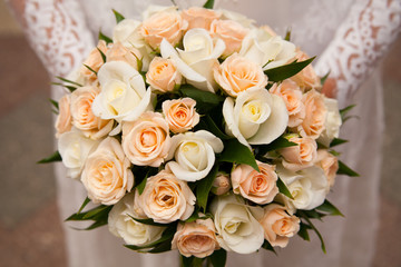 Beautiful wedding bouquet in hands of the bride