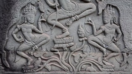 Bas-relief on the ancient wall in Angkor Thom temple complex in Cambodia. Apsara dance
