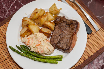 Steak meal with vegetables on a plate from above
