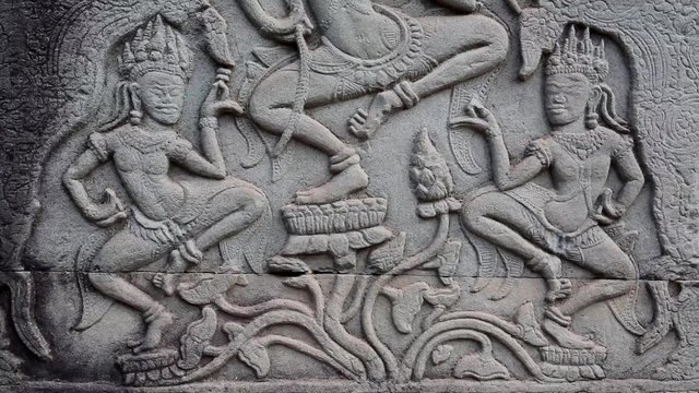 Bas-relief on the ancient wall in Angkor Thom temple complex in Cambodia. Apsara dance
