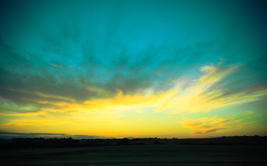 Naklejka na ściany i meble Beautiful sunset on a spring field