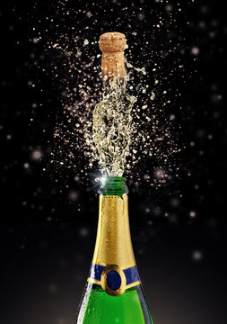 Celebration theme with splashing champagne on black