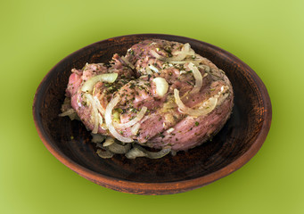 cooking meat. meat marinated with spices on a clay plate clouse-