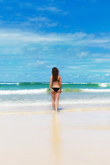 Fototapeta na wymiar Young pretty woman have sun bath on the cost of ocean