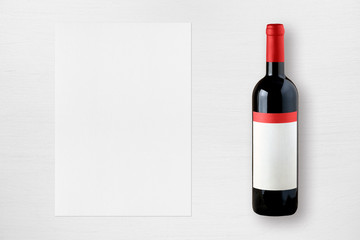 Wine bottle and paper for wine list on white table