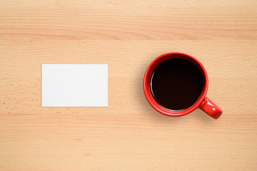 Business card and coffee cup on office desk