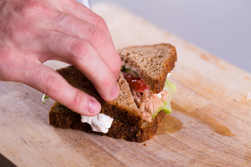 Cooking fresh homemade grilled tuna sandwich on wood