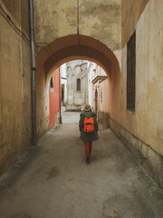 Girl with backpack walking in the old city