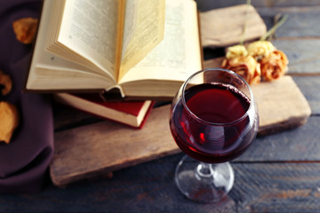 Naklejka na ściany i meble Beautiful composition with glass of wine with old books on table close up
