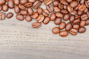 Coffee beans on wood background.