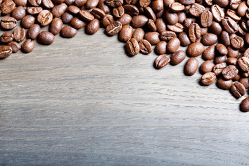 Roasted coffee beans on wood.