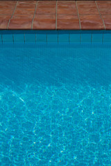 Fototapeta na wymiar Blue swimming pool - water ripples