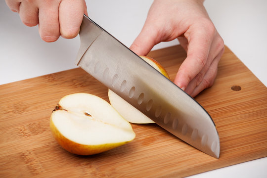 Cutting the fruit knife on a chopping board